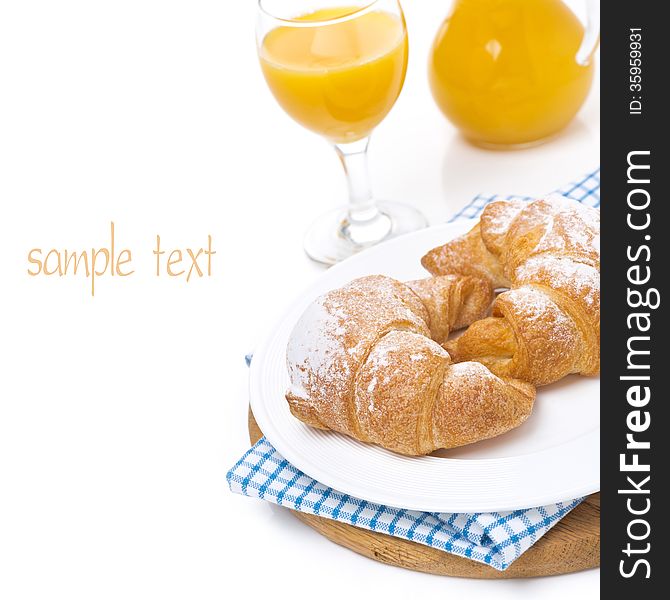 Croissants on a plate and orange juice, isolated on white
