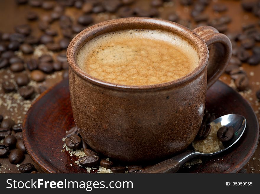 Cup of black coffee with foam, selective focus, close-up