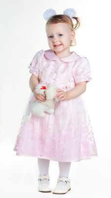 Little Girl Standing In Full Growth With Toy And Smiling Stock Photography