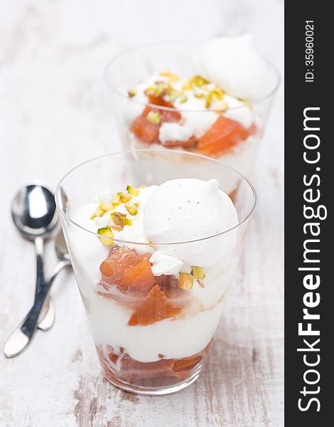 Dessert with peaches, whipped cream and meringue