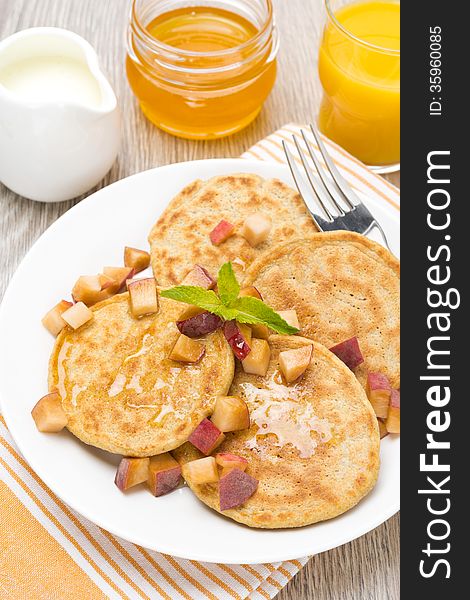 Pancakes with peaches and honey for breakfast, top view