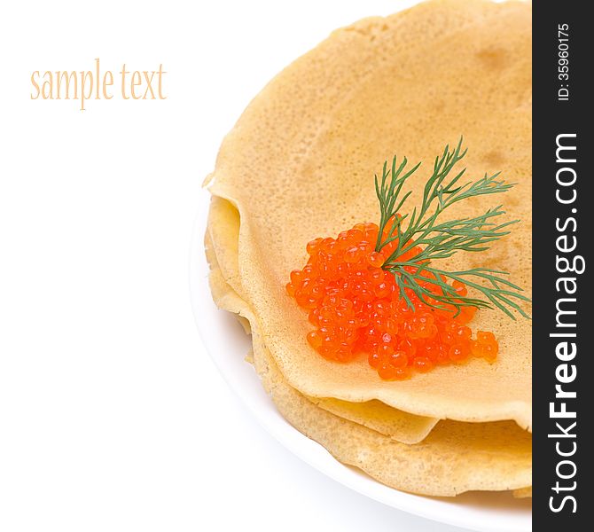 Stack of crepes with red caviar on a plate, close-up, isolated
