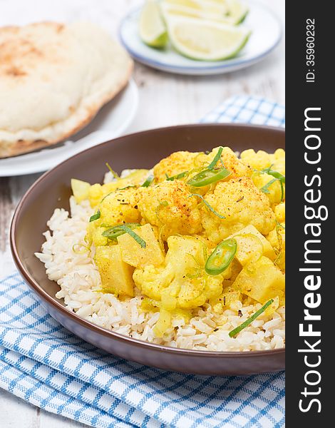 Vegetable curry with cauliflower and rice, close-up, vertical