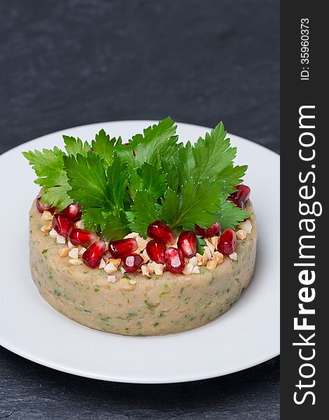 White bean pate with nuts and pomegranate seeds, vertical, close-up