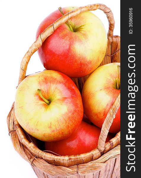 Delicious Ripe Red and Yellow Apples in Wicker Basket closeup on white background. Delicious Ripe Red and Yellow Apples in Wicker Basket closeup on white background