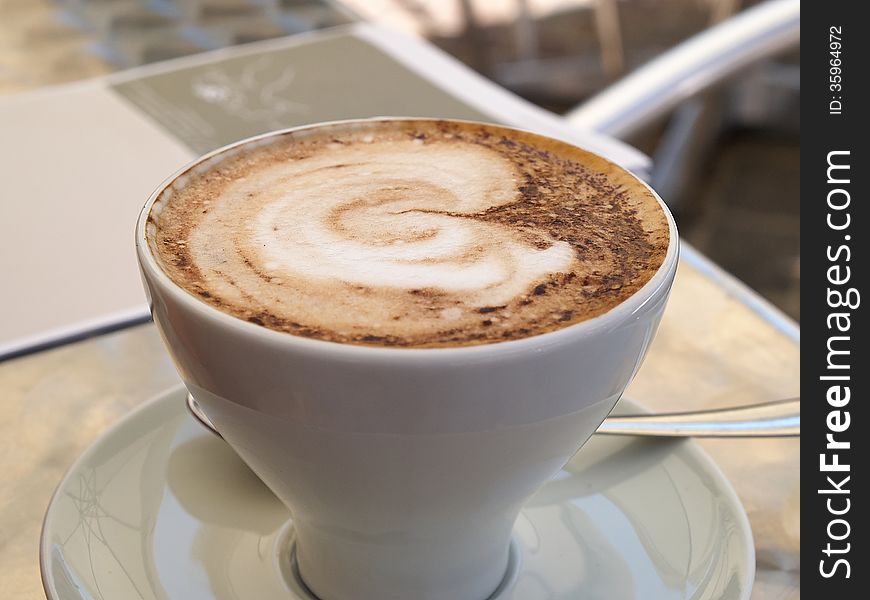 Hot cup of Cappuccino Coffee served in a cafe Italy