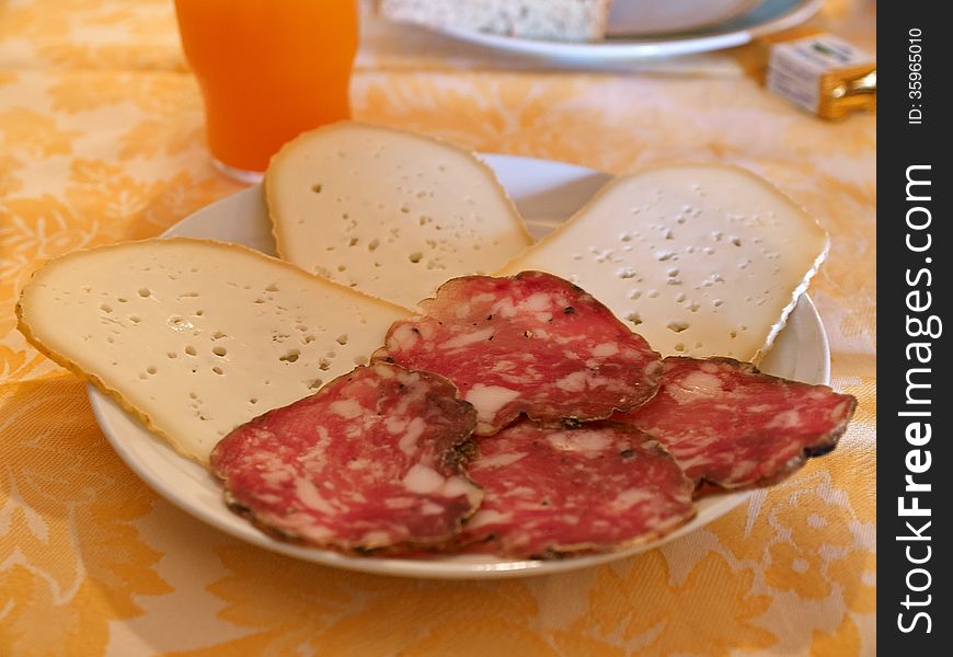 Typical Italian breakfast with cheese and traditional salami