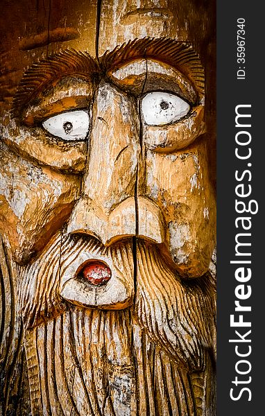 Detail Of A Man's Face With A Beard Carved Into Wood. Detail Of A Man's Face With A Beard Carved Into Wood