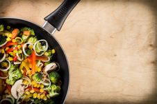 Frying Vegetables In Pan On Wood Background Stock Photos