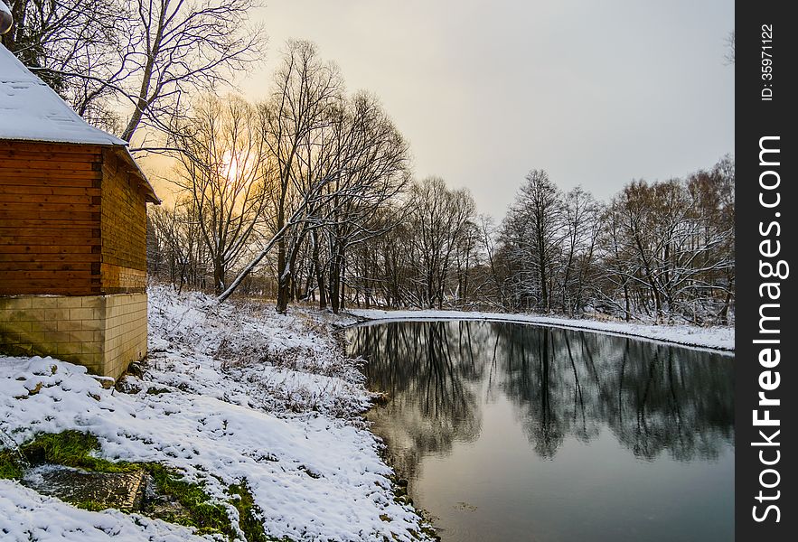 Landscape is not still pond with snowy shore. Landscape is not still pond with snowy shore