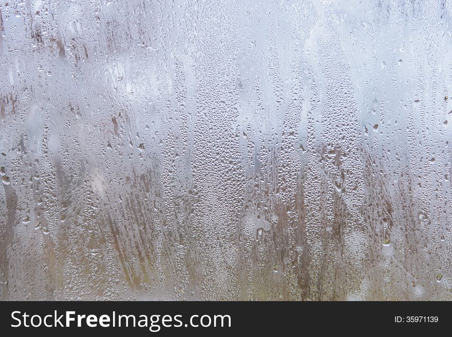 Rain drops on glass with a background. Rain drops on glass with a background