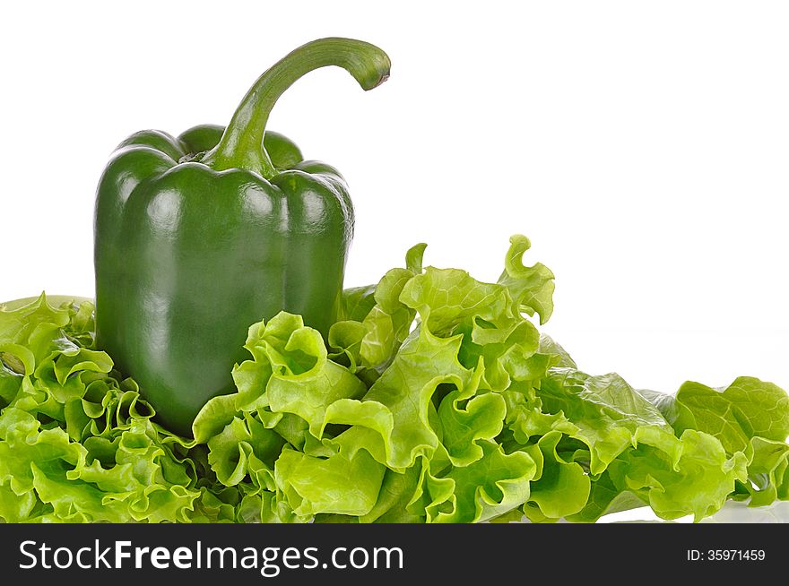 Green pepper and salad leaf isolated on white background