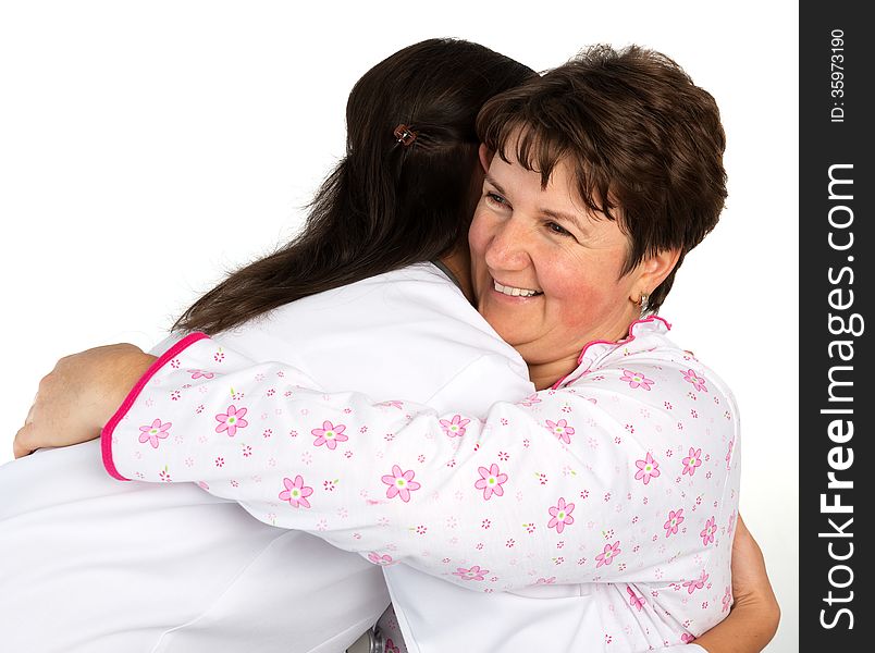 A senior women and nurse hugging in hospital. A senior women and nurse hugging in hospital