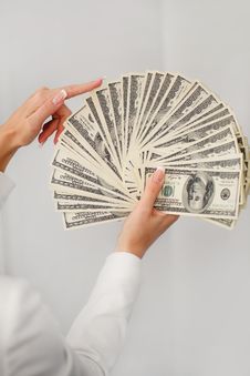 A Young Woman With Dollars In Her Hands, Isolated On White Royalty Free Stock Images A Young Woman With Dollars In Her Hands, Isolated On White Royalty Free Stock Images