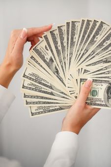 A Young Woman With Dollars In Her Hands, Isolated On White Stock Photo A Young Woman With Dollars In Her Hands, Isolated On White Stock Photo