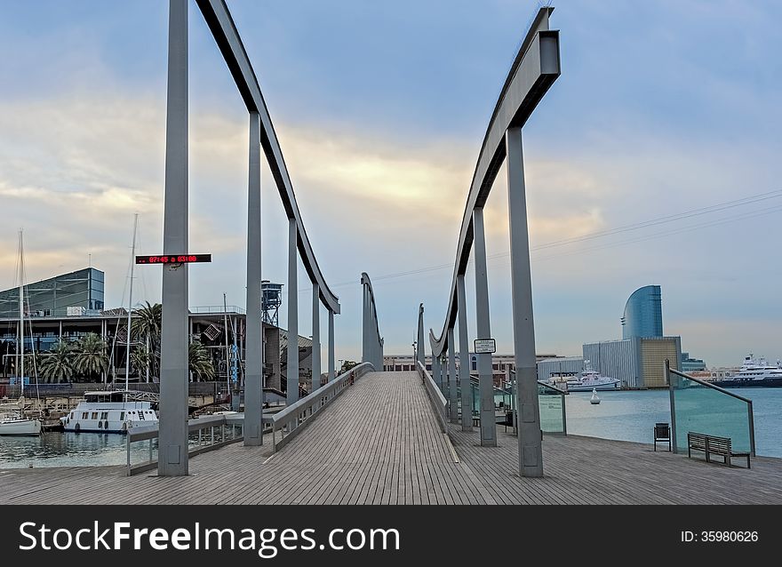 The Rambla de Mar was designed by Viaplana and Pinon, who created a wooden suspension bridge with a wavy pattern, symbolizing the connection of the city with the Mediterranean. The Rambla de Mar was designed by Viaplana and Pinon, who created a wooden suspension bridge with a wavy pattern, symbolizing the connection of the city with the Mediterranean.