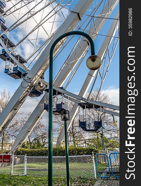 Low angle view of ferris wheel with blue sky background. Low angle view of ferris wheel with blue sky background.