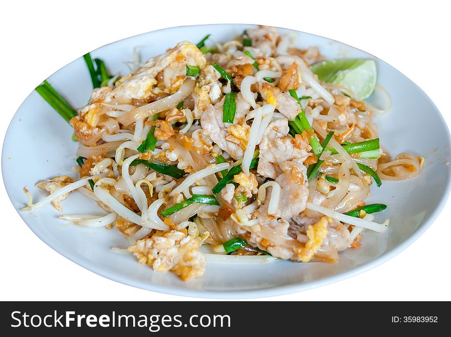 A delicious plate of Pad Thai with shrimp and chicken garnished with cilantro and lime.