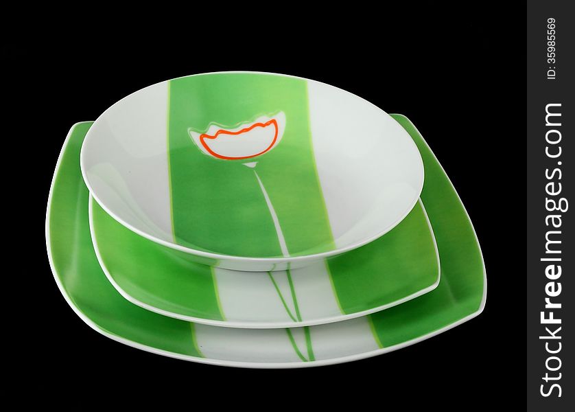 Hand-decorated tableware-green on a black background