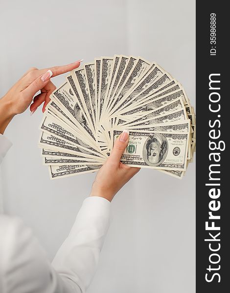 A Young Woman With Dollars In Her Hands, Isolated On White