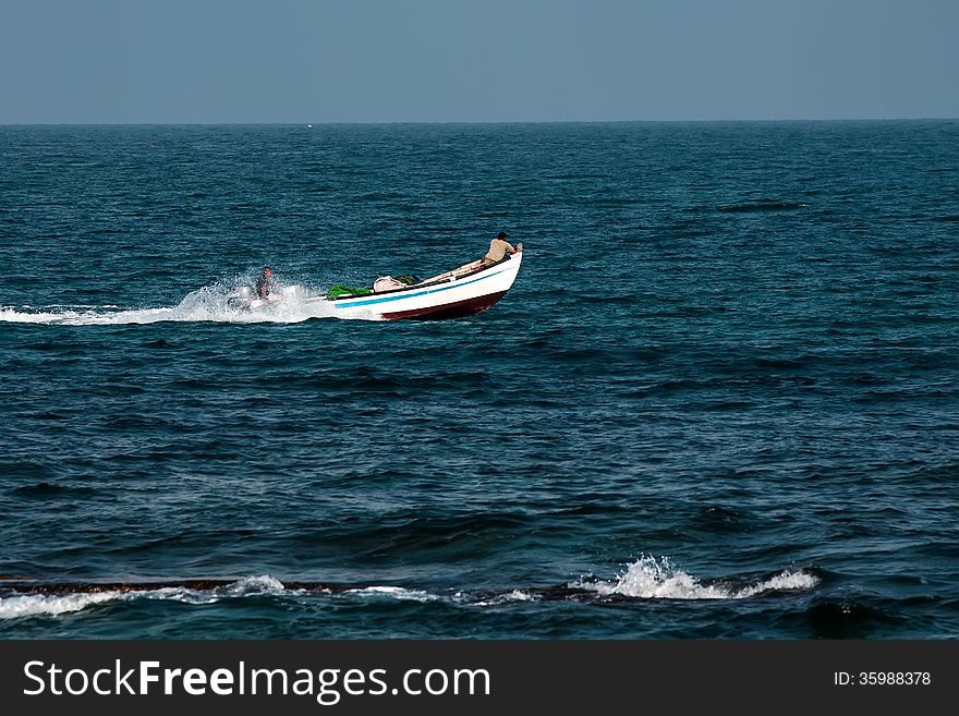 Fishermen on a motorboat background