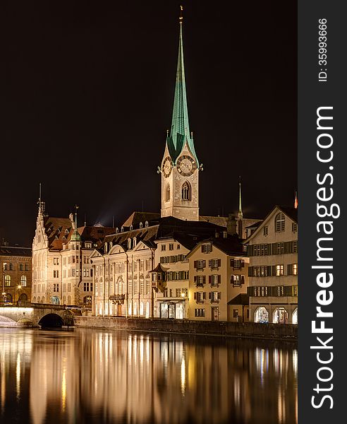 Zurich, Switzerland. The Lady Minster cathedral and the Limmat river in the evening. Zurich, Switzerland. The Lady Minster cathedral and the Limmat river in the evening.