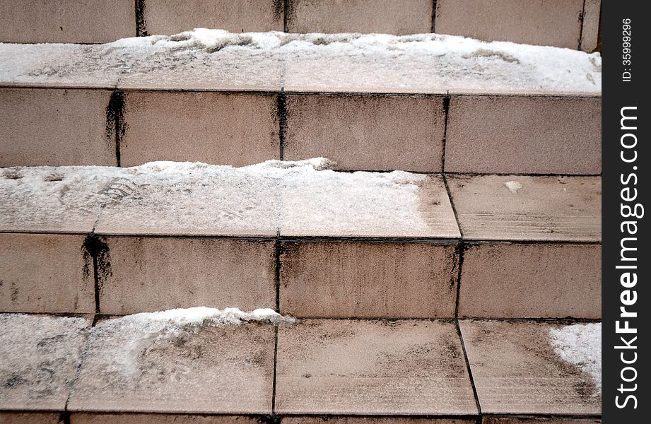 Fragment of the ladder which has been laid out by ceramic tiles. snow and ice lie on wet steps. therefore they very slippery. Fragment of the ladder which has been laid out by ceramic tiles. snow and ice lie on wet steps. therefore they very slippery.