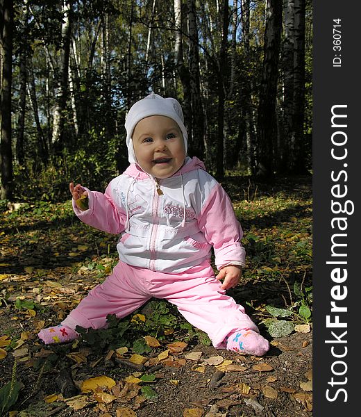 Baby on stump in autumn wood