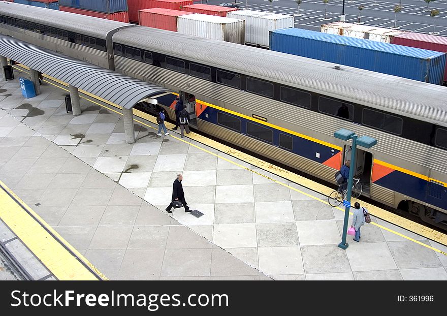 Morning commuters get on board at the train station. Morning commuters get on board at the train station.