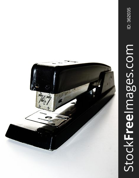 Black and metal stapler over white