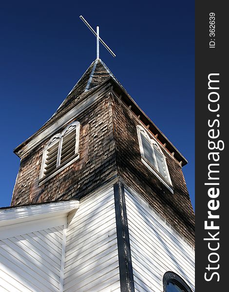 An old small town church in the midwest against a clear deep blue sky