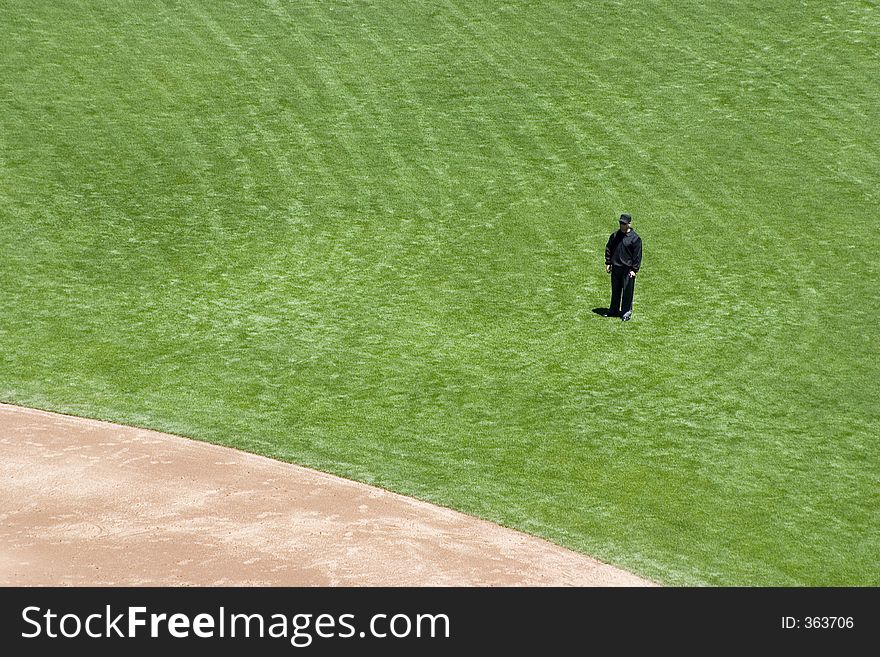 A baseball umpire, ready to make a call on a play. A baseball umpire, ready to make a call on a play.