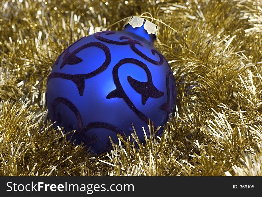 Blue christmas ornament on golden background. Blue christmas ornament on golden background