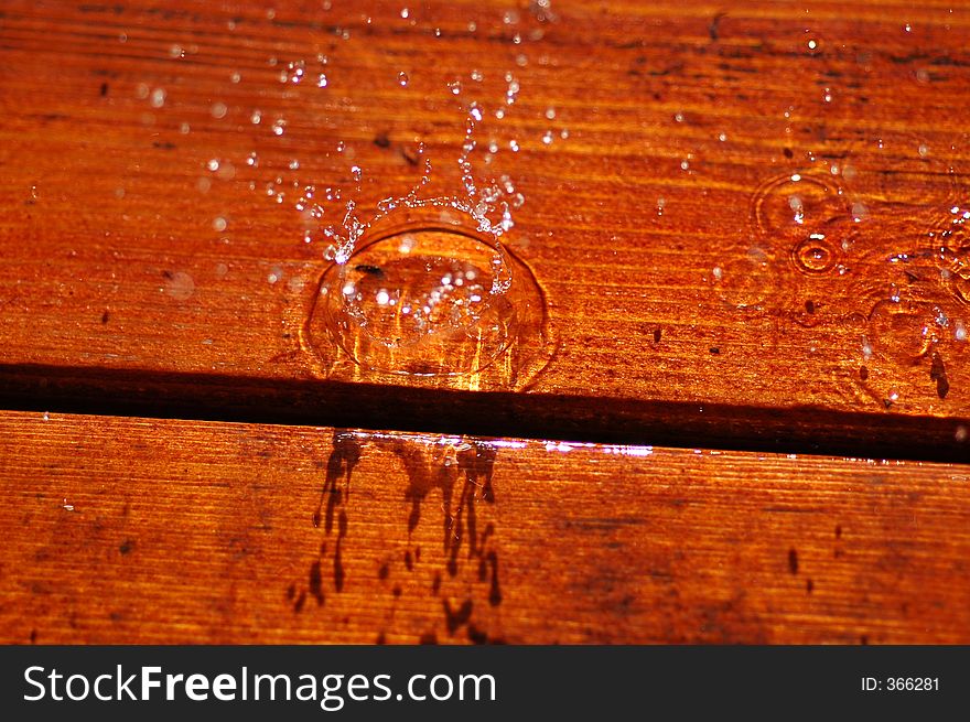 Water drops falling on wooden surface. Water drops falling on wooden surface.