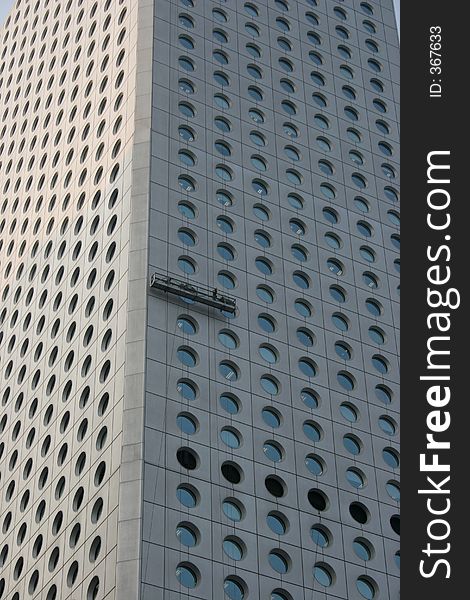 A skyscraper in Hong Kong - the window-washing crew happens to be at work. A skyscraper in Hong Kong - the window-washing crew happens to be at work.