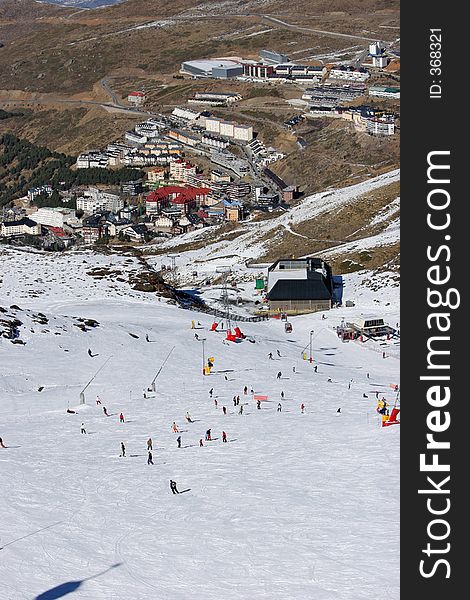 Looking down the busy ski slopes of the Sierra Nevada mountains in Spain to the resort town of Pradollano. Looking down the busy ski slopes of the Sierra Nevada mountains in Spain to the resort town of Pradollano