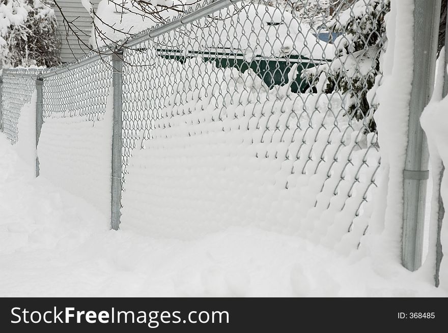 A Snow covered chain link fence. A Snow covered chain link fence