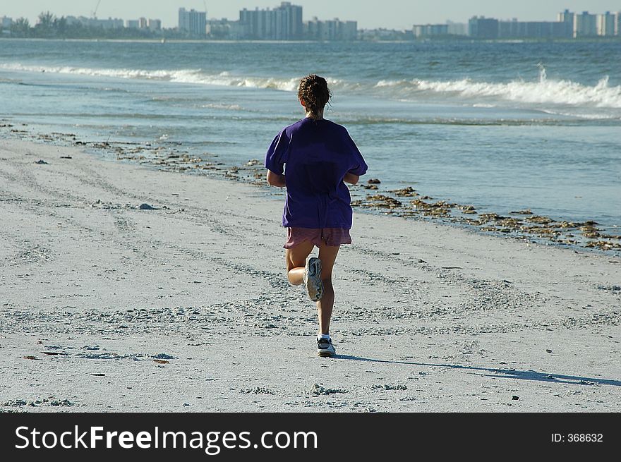 Photographed a lady jogging on the beach in Florida. Photographed a lady jogging on the beach in Florida.