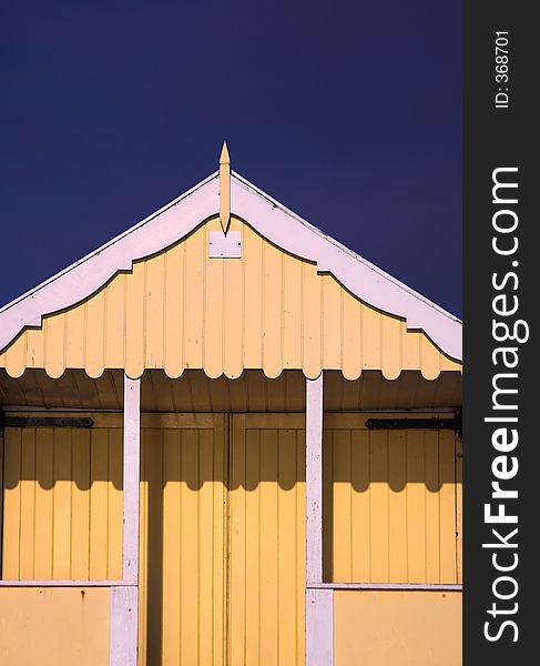 Yellow wooden beach hut, England
