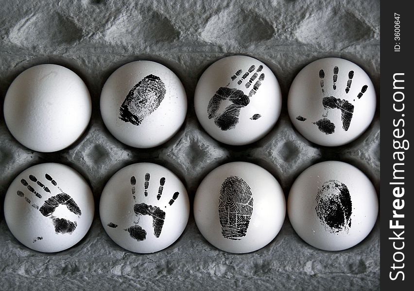 Eight eggs with finger and hand prints on the shell. Eight eggs with finger and hand prints on the shell.