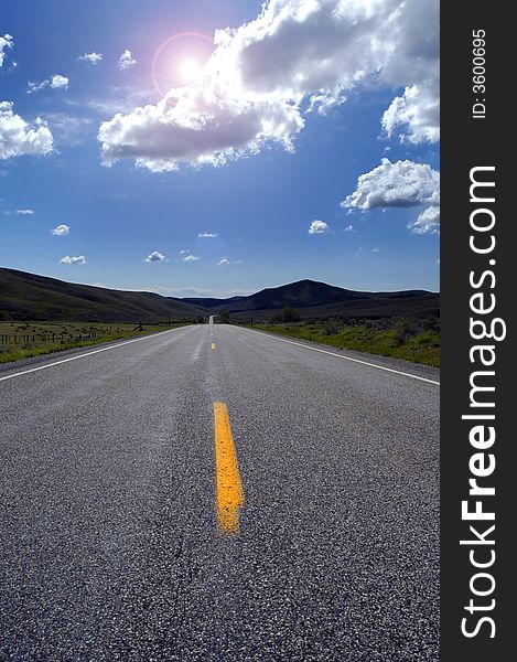 Country road with painted lines sunshine, sky and clouds. Country road with painted lines sunshine, sky and clouds