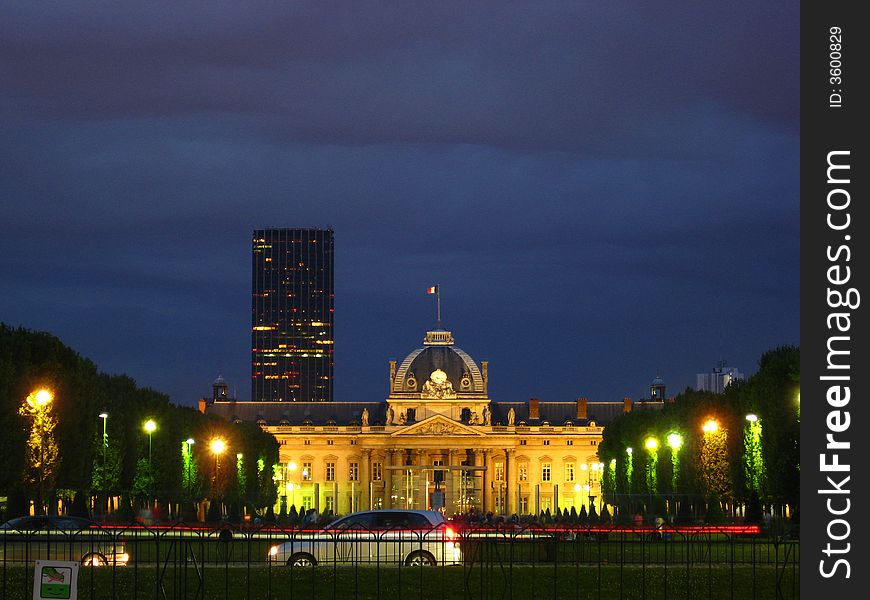 The Champs de Mars with Montparnasse Tower and the Ecole Militaire by night (the building opposed to the Eiffel Tower). Paris, France.