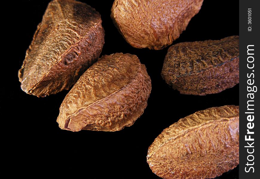 Unshelled brazil nuts against a black background. Unshelled brazil nuts against a black background.