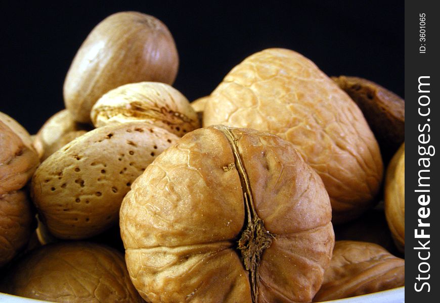 Mixed nuts against a black background. Mixed nuts against a black background.