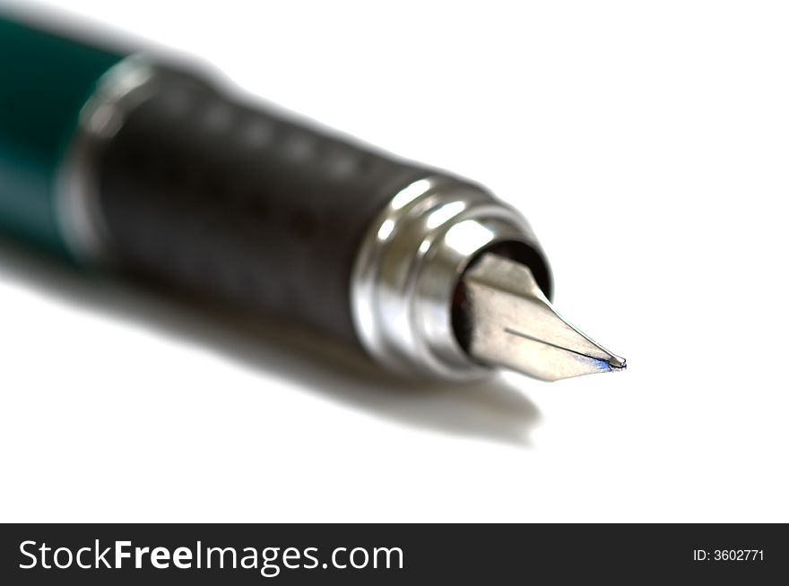 Fountain pen on white with very shallow depth of field on white background, focus is on the tip of the pen