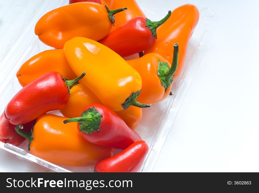 Fresh sweet peppers on white background, with copy space