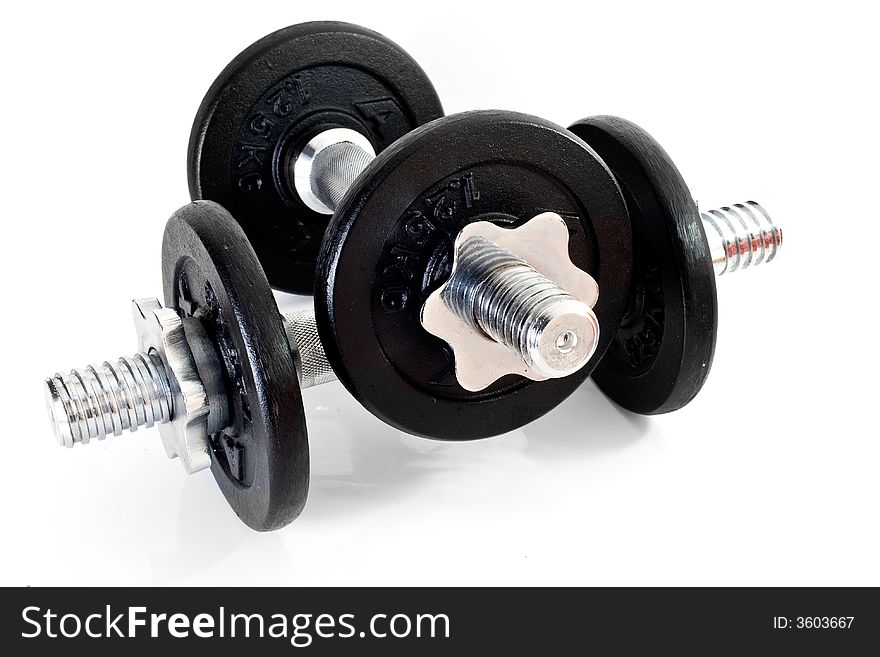 A set of chrome dumbells with twist off speed rings on white. A set of chrome dumbells with twist off speed rings on white
