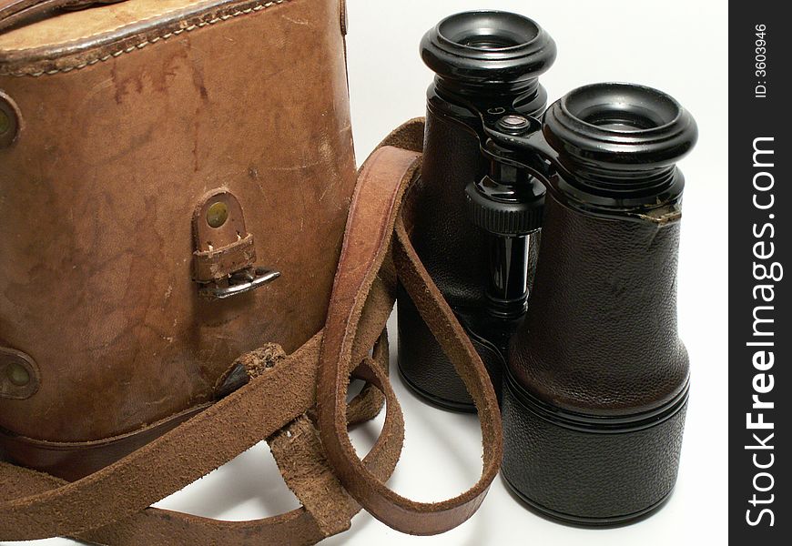 Old military binoculars with leather case on white background. Old military binoculars with leather case on white background