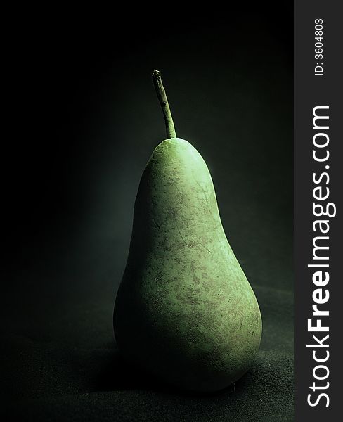 One pear on black background.