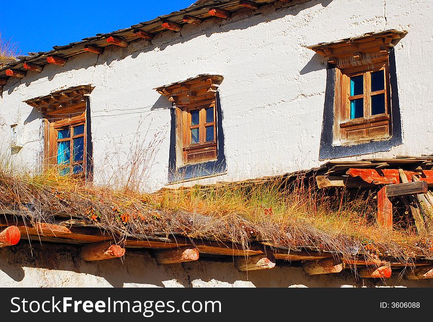 It's Tibet style house with tradition wood windows and white wall.